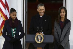 U.S. President Obama and his daughters Malia and Sasha appear at the North Portico of the White House to pardon the annual Presidential turkey in Washington